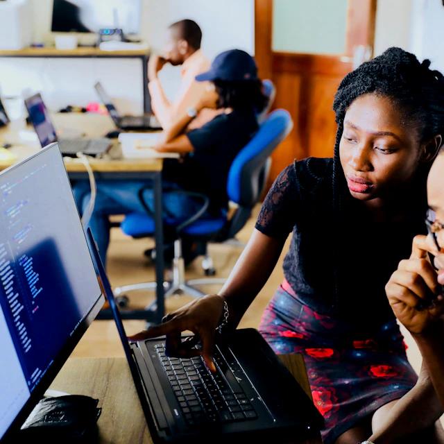 Two engineers pair-programming at a screen