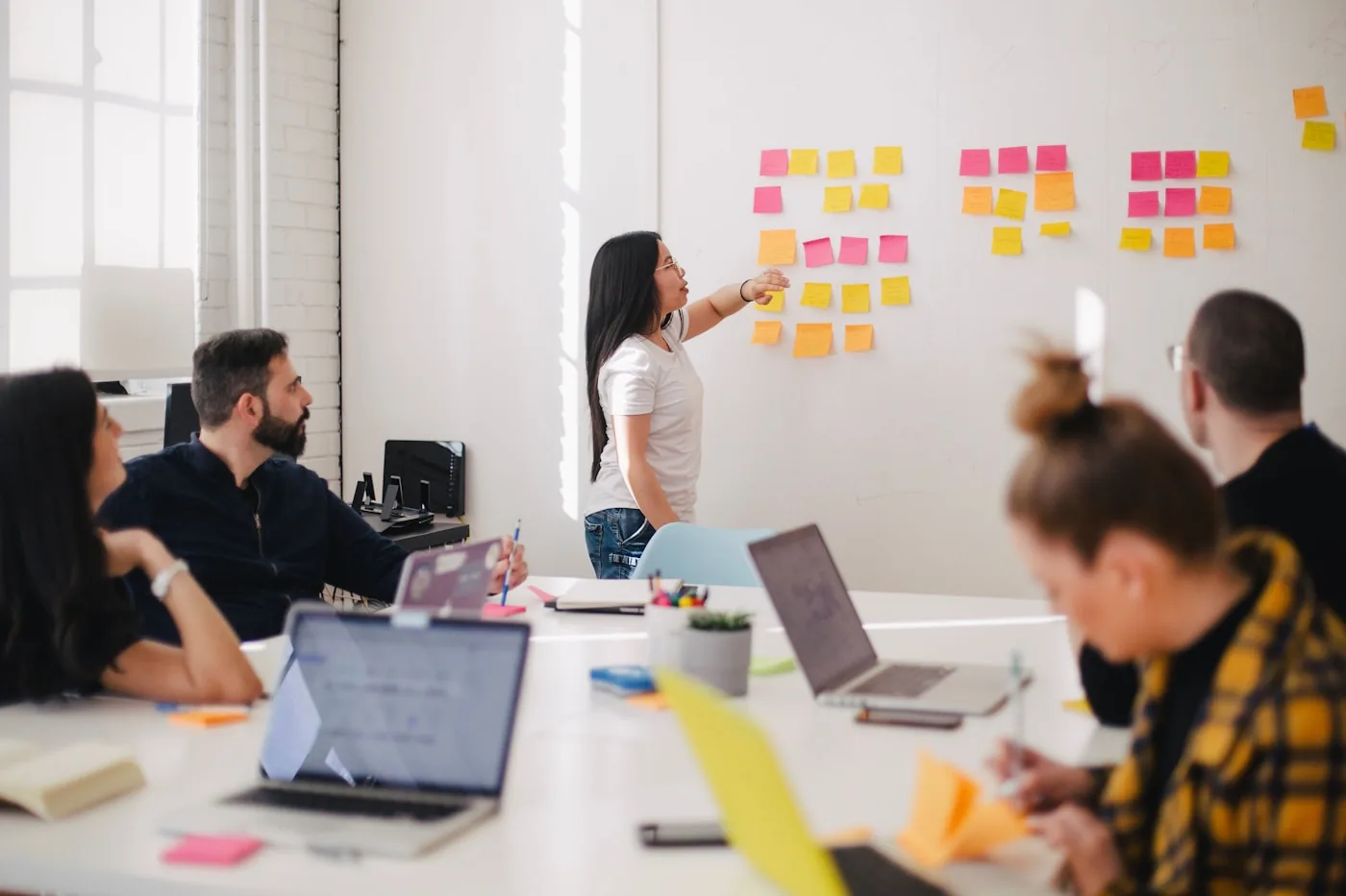 TechJan strategists mapping a product on a wall of sticky notes during a discovery workshop