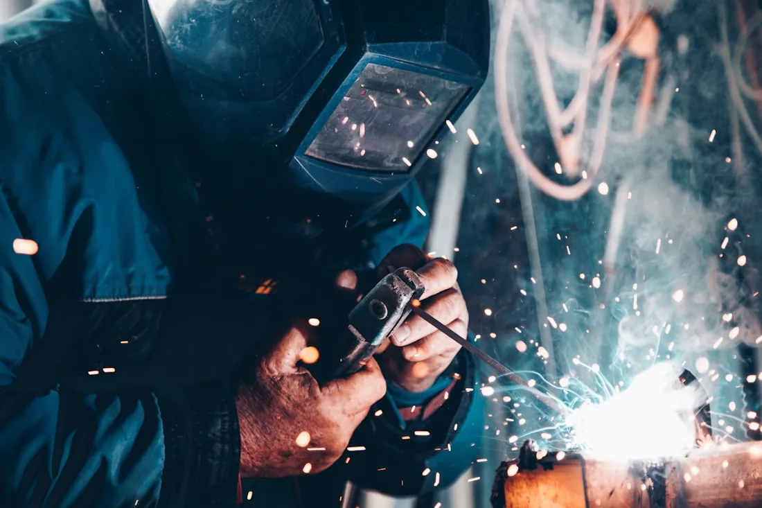 A welder at work with sparks flying