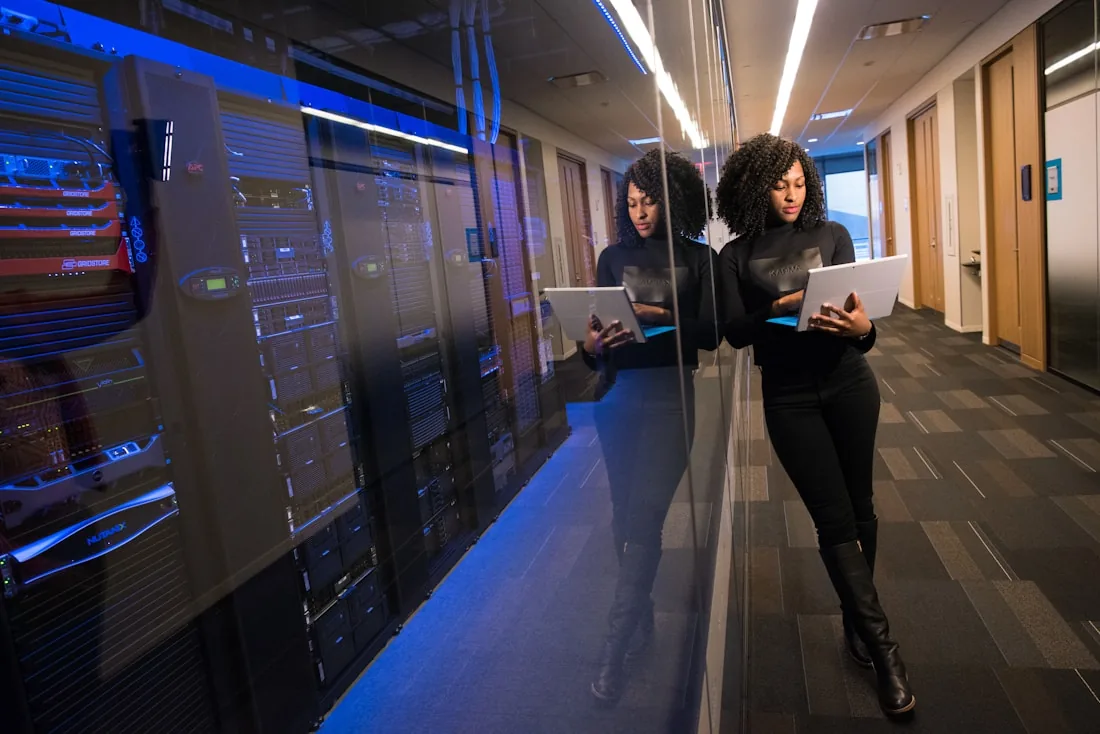 An engineer beside server racks